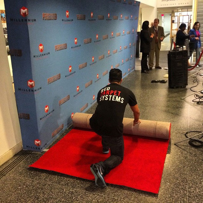 Setting up a step and repeat wall and red carpet