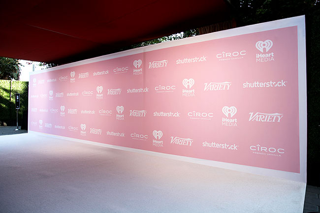 Pink step and repeat backdrop with white event carpet runner