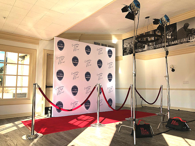 Step and repeat backdrop and red carpet setup for retirement party