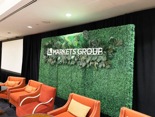 green hedge wall with 3D letters