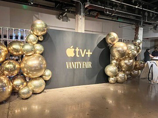 black backdrop showcasing the Apple TV+ and Vanity Fair's logos