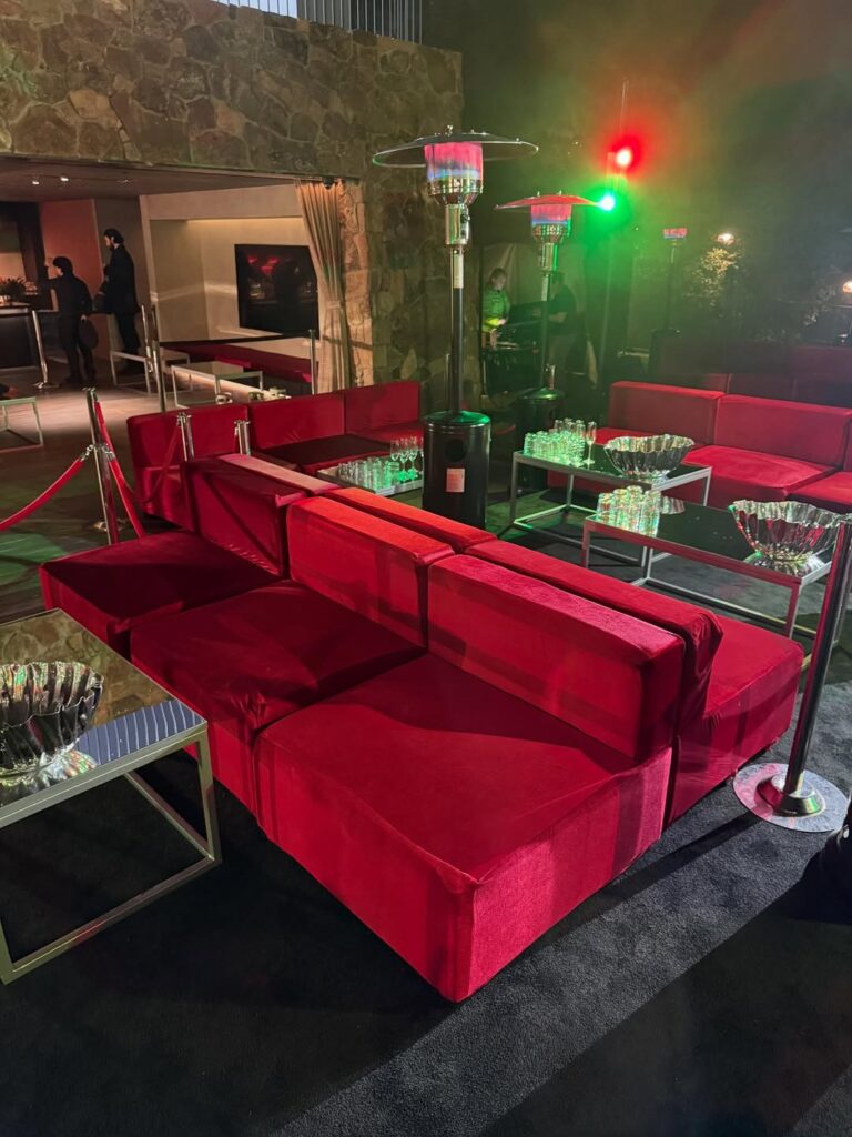 red sofas, tables and heat lamps