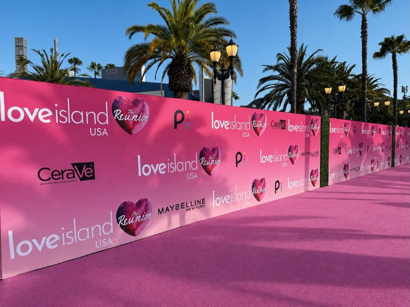 Love Island USA Season 8 Reunion Pink step and repeat backdrop installation at Universal Studios Hollywood by Red Carpet Systems.